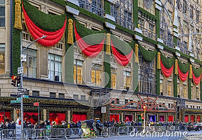 Christmas decorations red ribbons, wreaths and lights on the flagship Saks Fifth Avenue store in Manhattan New York, USA Editorial Stock Photo