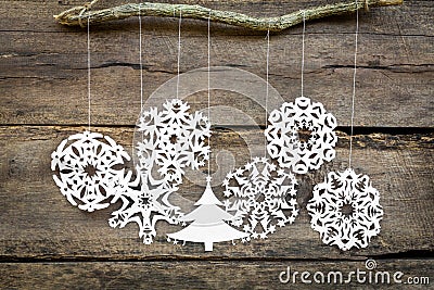 Christmas decorations snowflake ,christmas tree paper hanging over wooden background Stock Photo