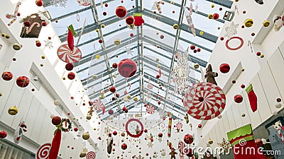 Christmas decorations and toys hang on thin threads. Abstract background of New Year`s decor in the mall, airport or station room Stock Photo