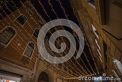 Christmas decorations in Venetian street with luxury boutiques, Venice, Italy Editorial Stock Photo