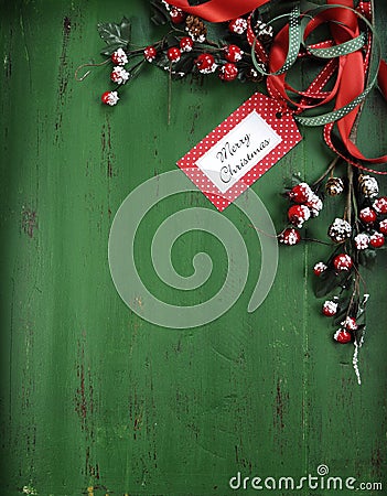 Christmas decorations on vintage green wood background. Vertical with Merry Christmas tag. Stock Photo