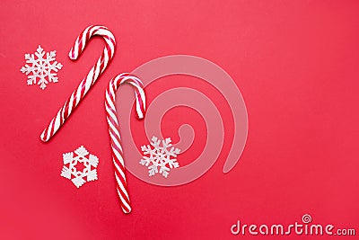 Christmas decors snowflakes and candy cane on red background Stock Photo