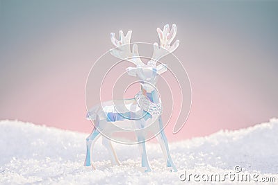 Christmas deer toy figurine in cold pastel light colors. Stock Photo