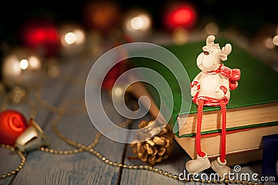 A Christmas deer toy sits on books Stock Photo