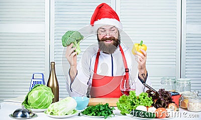 Christmas diet. Healthy christmas holiday recipes. How make your christmas dinner healthier. Man bearded chef wear santa Stock Photo