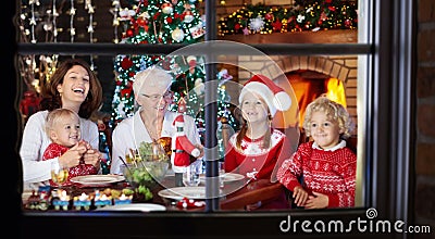 Christmas dinner. Family with kids at Xmas tree. Stock Photo