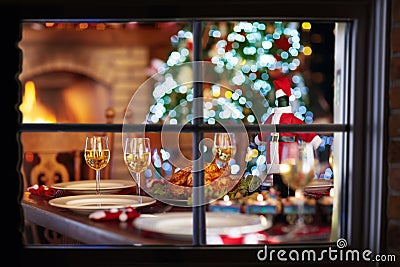 Christmas dinner at fire place and Xmas tree. Stock Photo