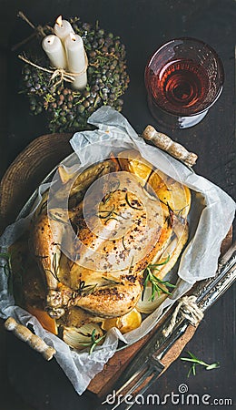 Christmas dinner with roasted whole chicken, decorative candles and wine Stock Photo