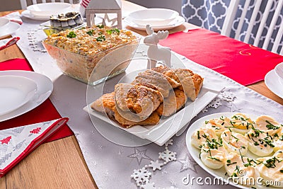 Christmas dinner table with fried salmon fillets and eggs mayonnaise Stock Photo