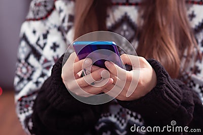 Christmas discounts. Girl chooses gifts on a mobile phone Stock Photo