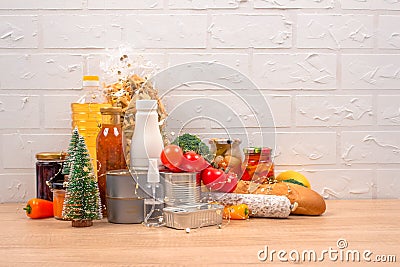 Christmas donations - food donations on light background with copy space - pasta, fresh vegatables, canned food, baguette, cooking Stock Photo