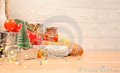 Christmas donations - food donations on light background with copyspace - pasta, fresh vegatables, canned food, baguette Stock Photo