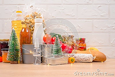 Christmas donations - food donations on light background with copyspace - pasta, fresh vegatables, canned food, baguette, cooking Stock Photo