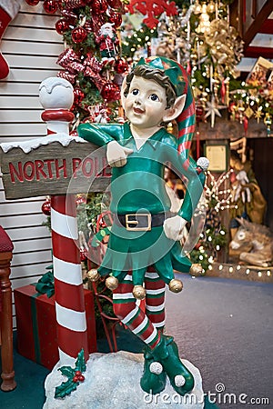 Christmas Elf and North Pole sign Stock Photo