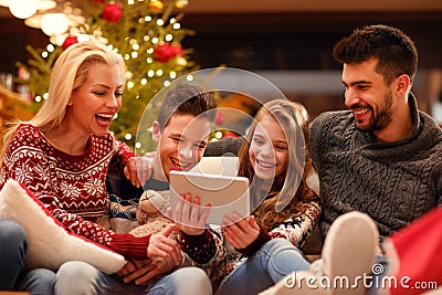 Christmas entertainment at home family watching video on digital Stock Photo