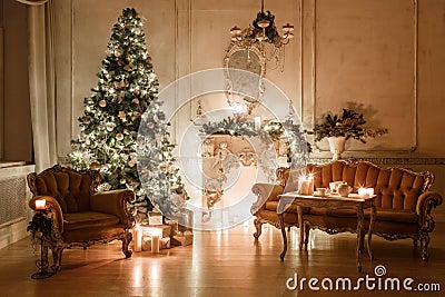 Christmas tree, garlands, candles,lanterns, gifts in the evening. classical interior of a white room with a decorated Stock Photo