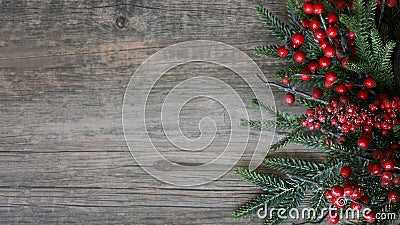 Christmas Evergreen Branches and Berries Over Rustic Wood Horizontal Background Stock Photo