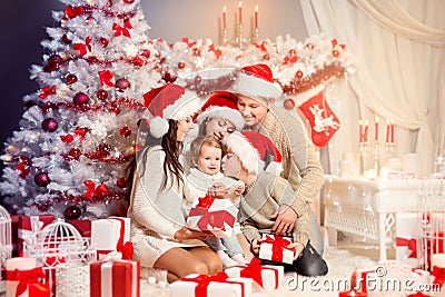 Christmas Family Front of Xmas Tree Opening Present Gifts, Happy Father Mother Children Stock Photo