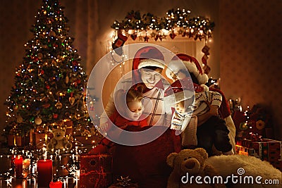 Christmas Family Open Present Gift, Xmas Tree Lights Interior Stock Photo