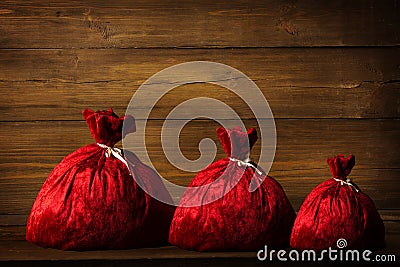 Christmas Family Santa Claus Bags, Xmas Red Sackful Wood Wall Stock Photo