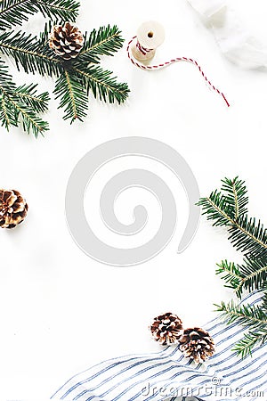 Christmas festive composition. Decorative floral frame. Fir tree branches border. Pine cones, gift rope, ribbon and Stock Photo