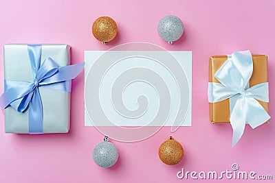 Christmas festive mock up with blank page, wrapped gifts and baubles on pink Stock Photo