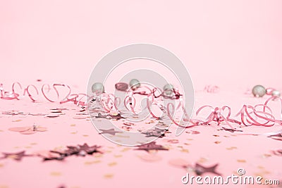 Christmas festive pink background with serpentine and festive toys Stock Photo