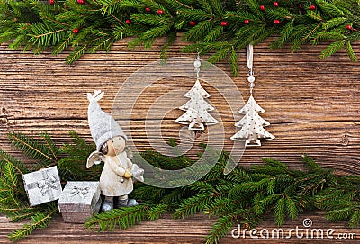 Christmas fir tree, Christmas tree toys, gifts on old wooden board background. Toned Stock Photo