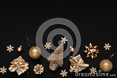 Christmas flat lay of decorations in golden monochrome tones on black background Stock Photo