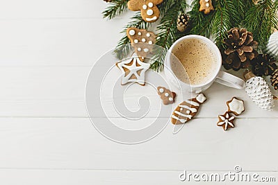 Christmas flat lay with gingerbread cookies, coffee, pine cones and branches on white table Stock Photo