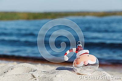 Christmas in Florida concept, santa ornament on beach Stock Photo