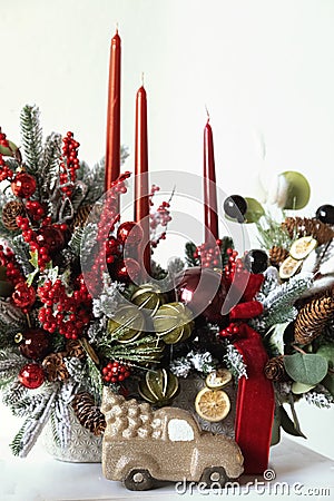 Christmas flower composition of spruce branches, cotton flowers, cinnamon, Christmas glass balls, ribbons and gray Ceramic owl for Stock Photo
