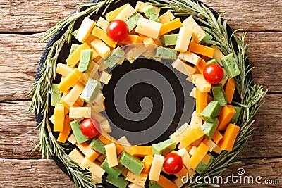 Christmas food: a wreath of pesto cheese, cheddar, mimolette wit Stock Photo