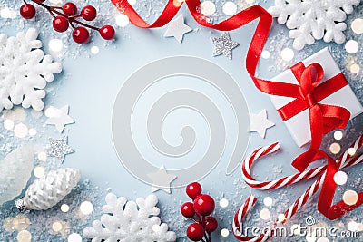 Christmas frame, greeting card. Gift or present box and holiday decoration on blue background top view. Happy New Year composition Stock Photo