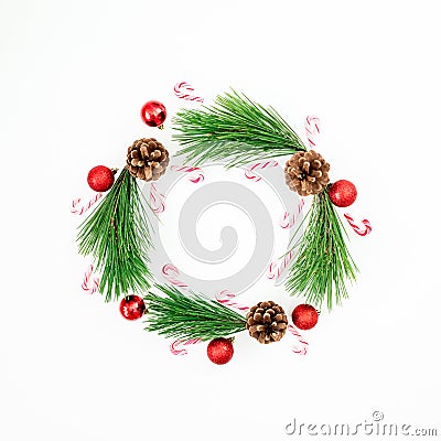 Christmas frame made of pine branches and red balls decoration with candy cane on white background. Festive background. Flat lay, Stock Photo