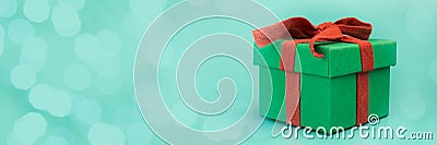 Christmas gift banner, holiday present, green box with red ribbon Stock Photo