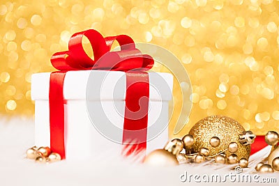 Christmas gift box against gold bokeh background Stock Photo