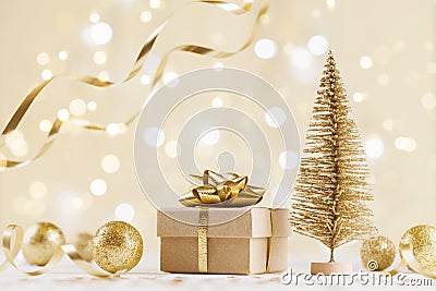 Christmas gift box against golden bokeh background. Holiday greeting card. Stock Photo