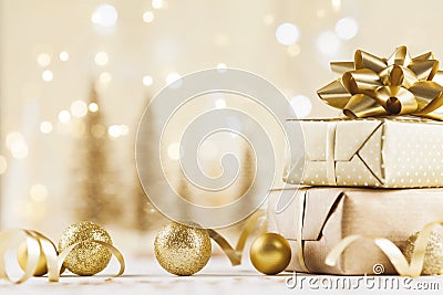 Christmas gift box against golden bokeh background. Holiday greeting card. Stock Photo
