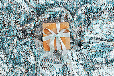 Christmas gift box against turquoise bokeh background. Stock Photo