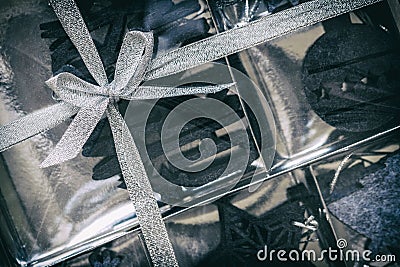 Christmas gift box with silver bow and creative black Christmas decorations Stock Photo