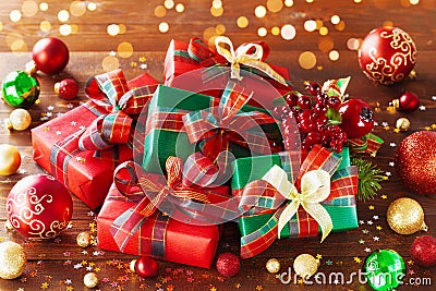 Christmas gift boxes with holiday lights on wooden background Stock Photo