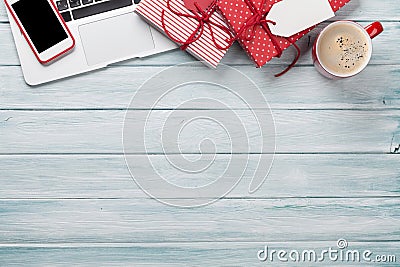 Christmas gift boxes, pc and coffee cup on wood Stock Photo