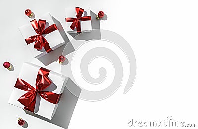 Christmas gift boxes with red ribbon and decoration on white background with bokeh, light. Xmas and Happy New Year holiday Stock Photo