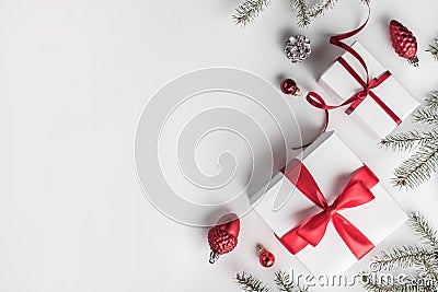 Christmas gift boxes on white background with Fir branches, pine cones, red decoration Stock Photo