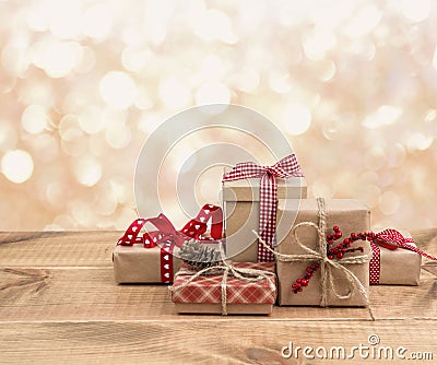 Christmas gift boxes on wooden table over abstract lights background Stock Photo