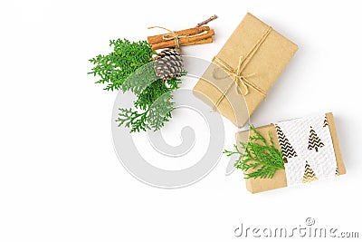 Christmas gift boxes wrapped in brown craft paper tied with twine pine cones juniper cinnamon on white. New Year presents Stock Photo
