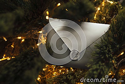 Christmas Gift envelope on Christmas tree background . Christmas certificate. Stock Photo