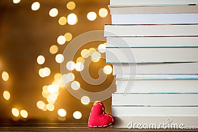 Christmas gift heart shape and pile of books Stock Photo
