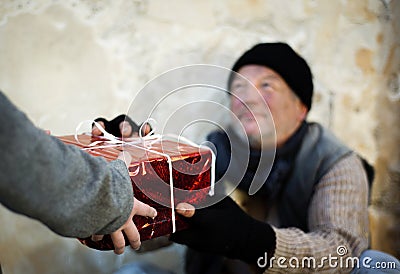 Christmas gift for homeless man Stock Photo